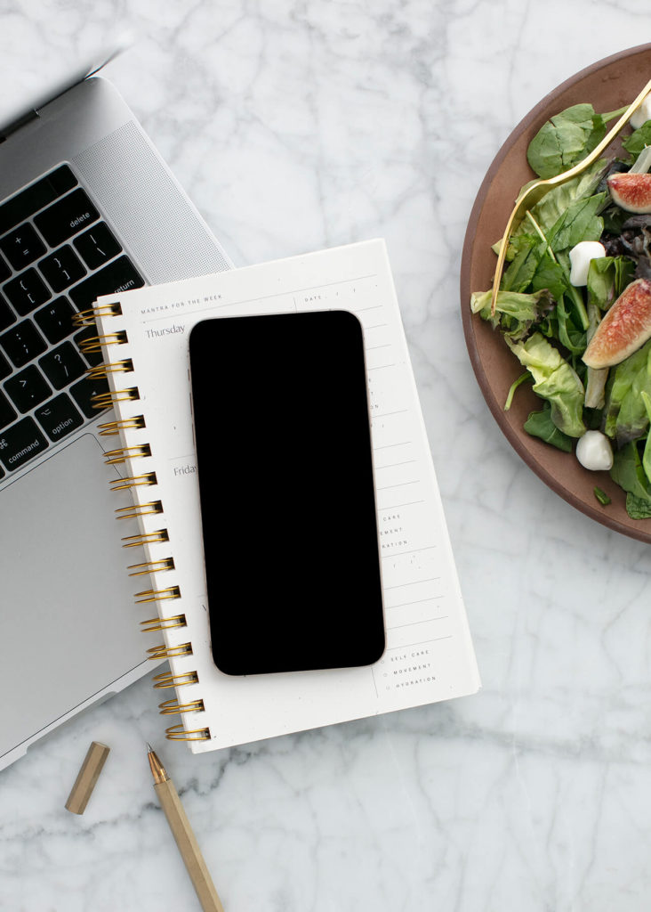 setting health goals, healthy salad, phone, diary